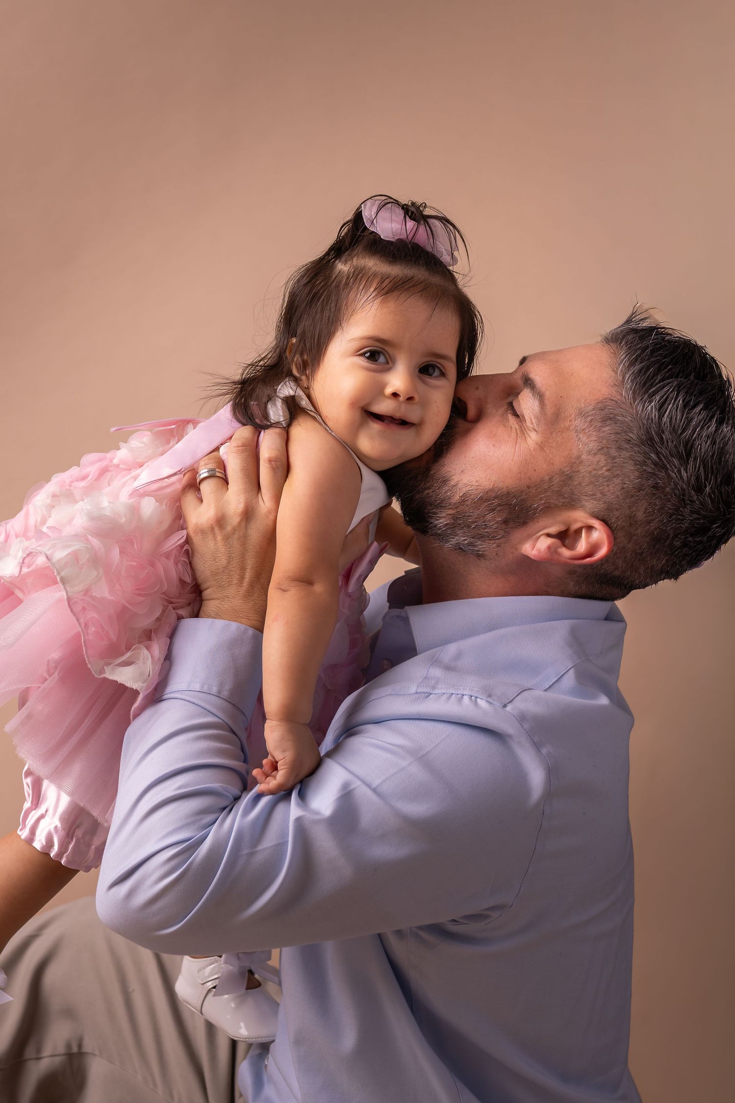 A sequence of tender moments captured in warm lighting against a neutral backdrop.