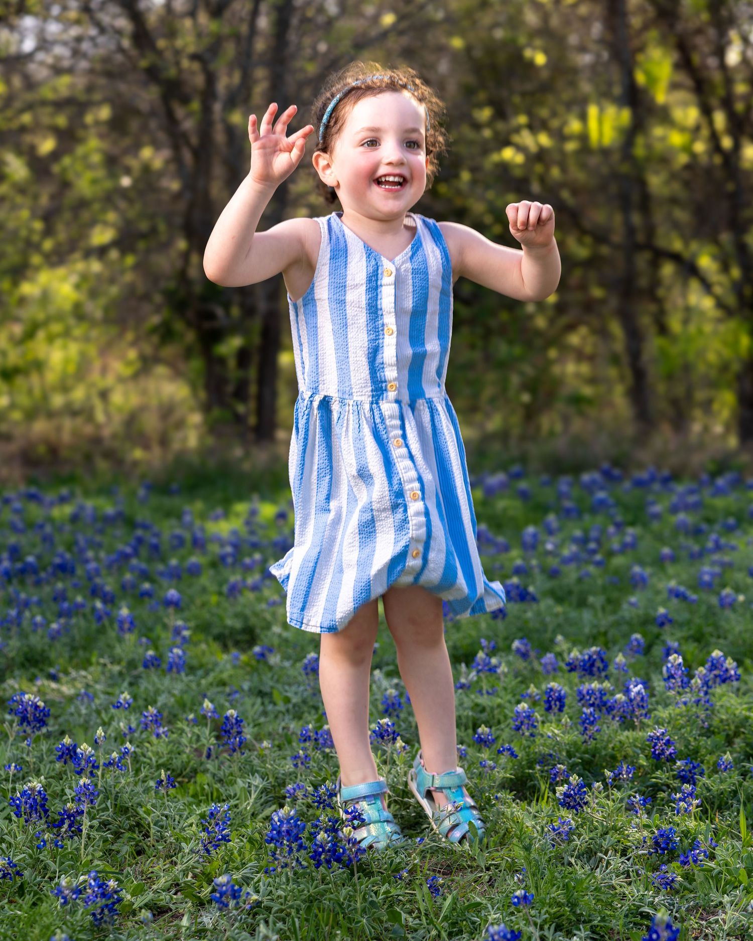 A joyful moment captured in a field of blooming bluebonnets as someone leaps and plays among the spring flowers.