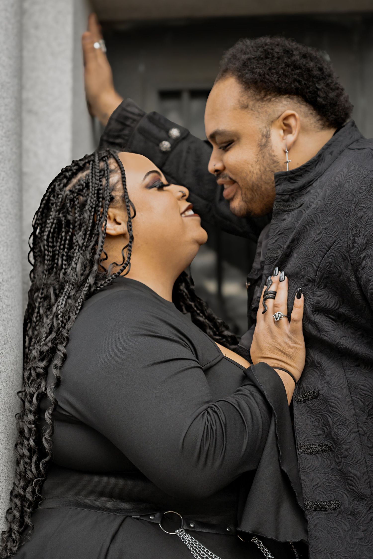 A romantic sequence of photos showing a joyful couple laughing and embracing in black outfits against a dark background.