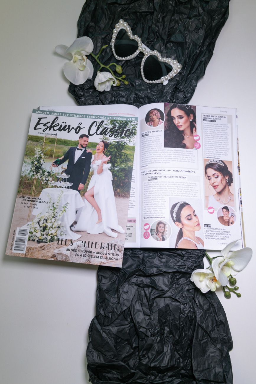 A wedding magazine spread with heart-shaped sunglasses and white orchids on black textured fabric background.
