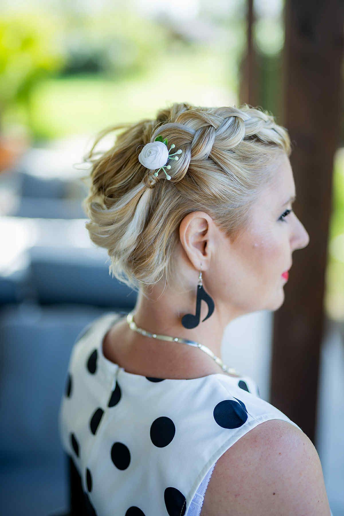 A side profile portrait shows an elegant updo hairstyle adorned with a delicate butterfly hair accessory.