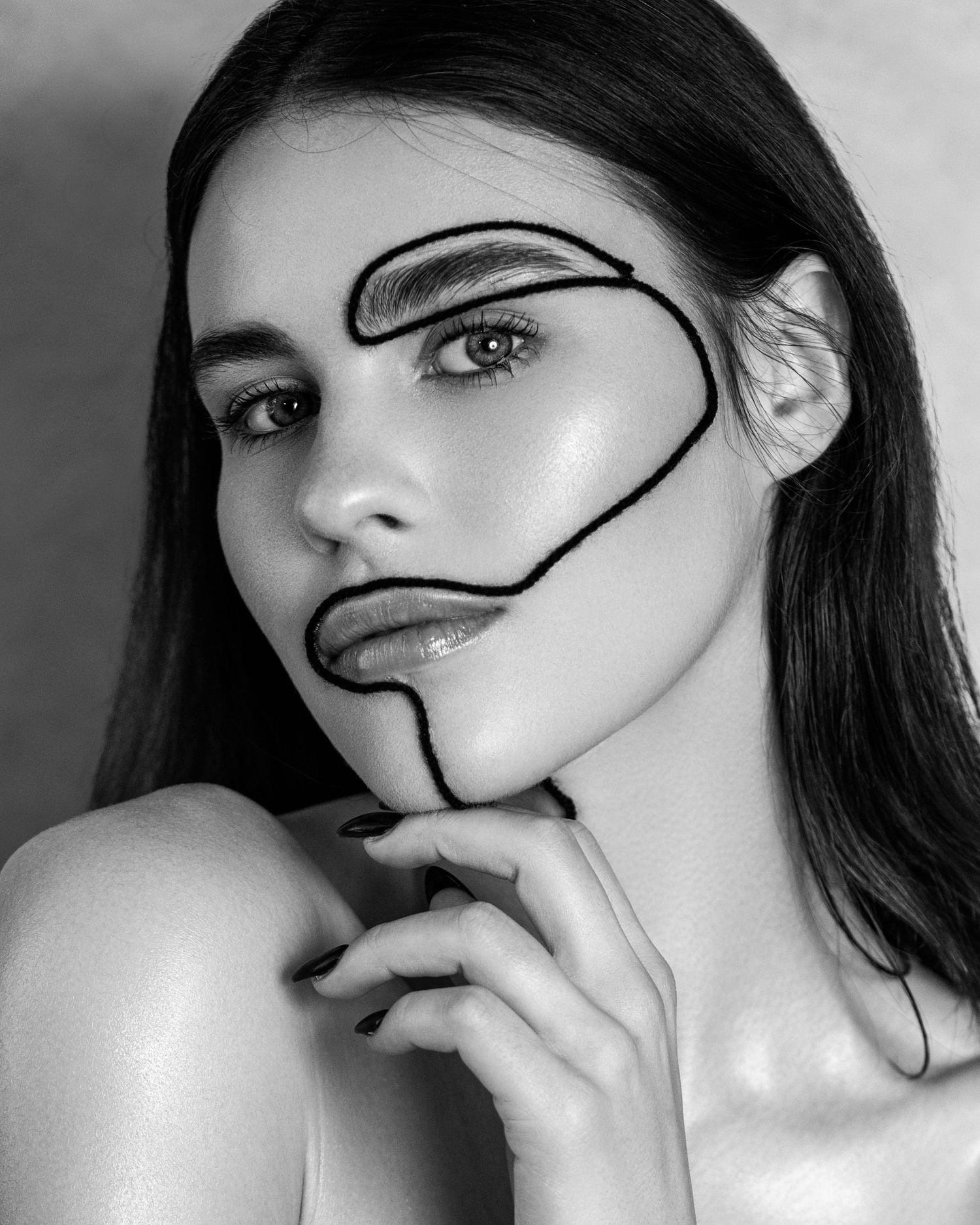 Artistic black and white beauty portrait with abstract line art drawn on face.