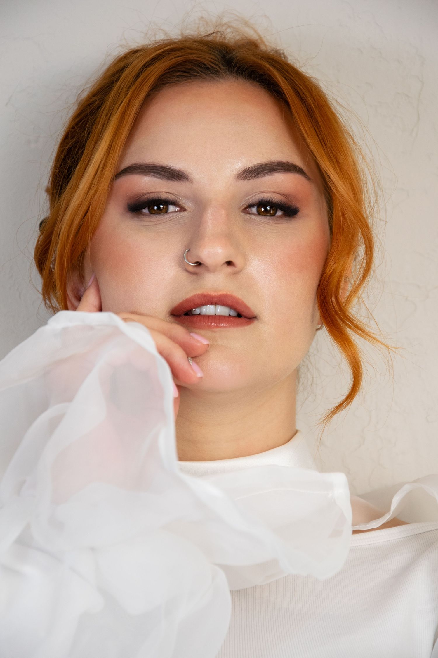 A fashion portrait series showing dramatic poses with flowing white fabric against a light background.