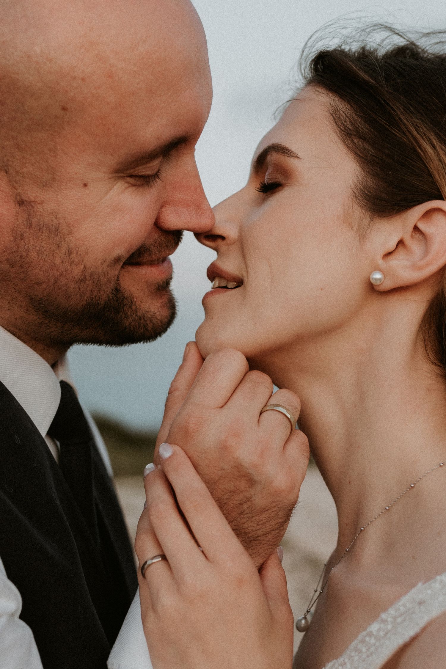 A loving couple shares an intimate moment with gentle kisses in a series of romantic wedding photos.