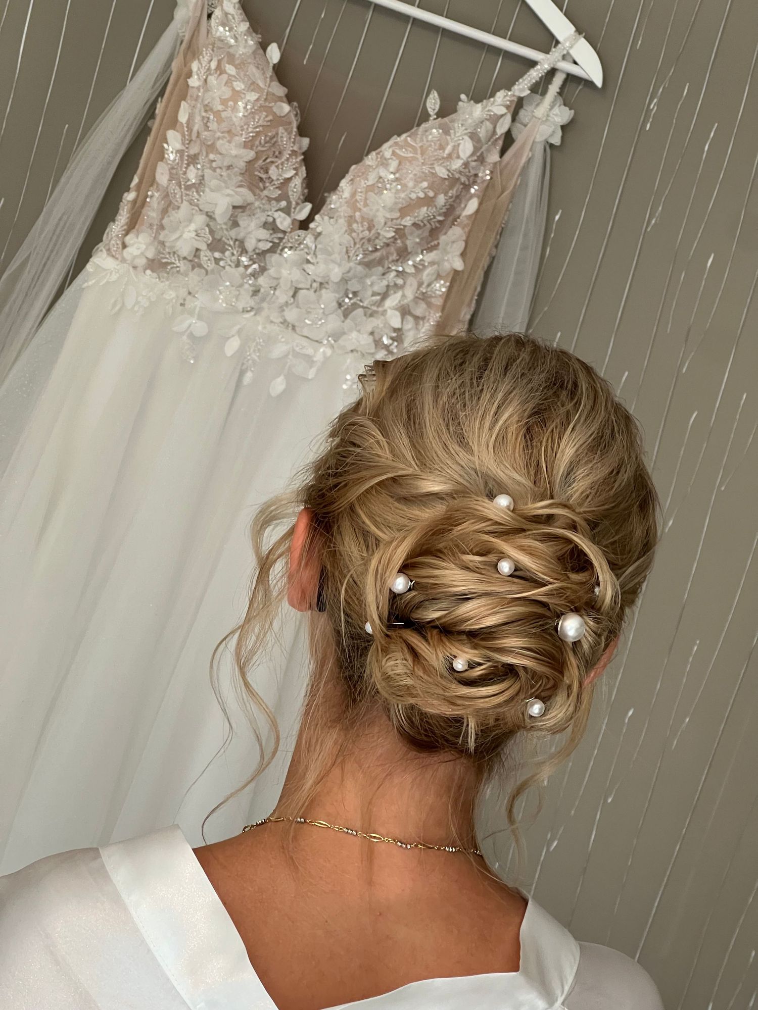 A wedding day hairstyle progression showing different angles of an elegant blonde updo with braided details.
