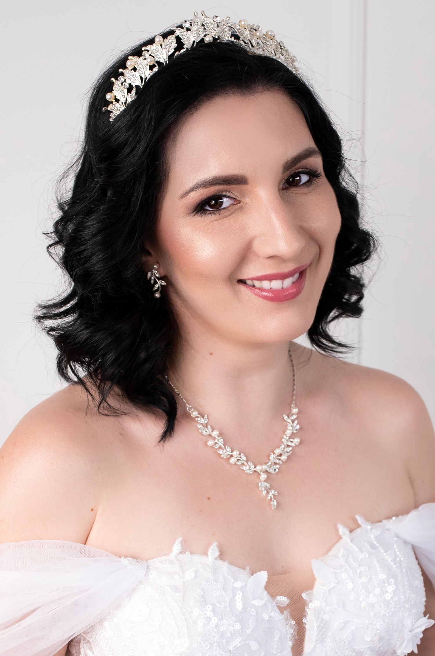 Romantic bridal portrait with crystal tiara and delicate necklace.