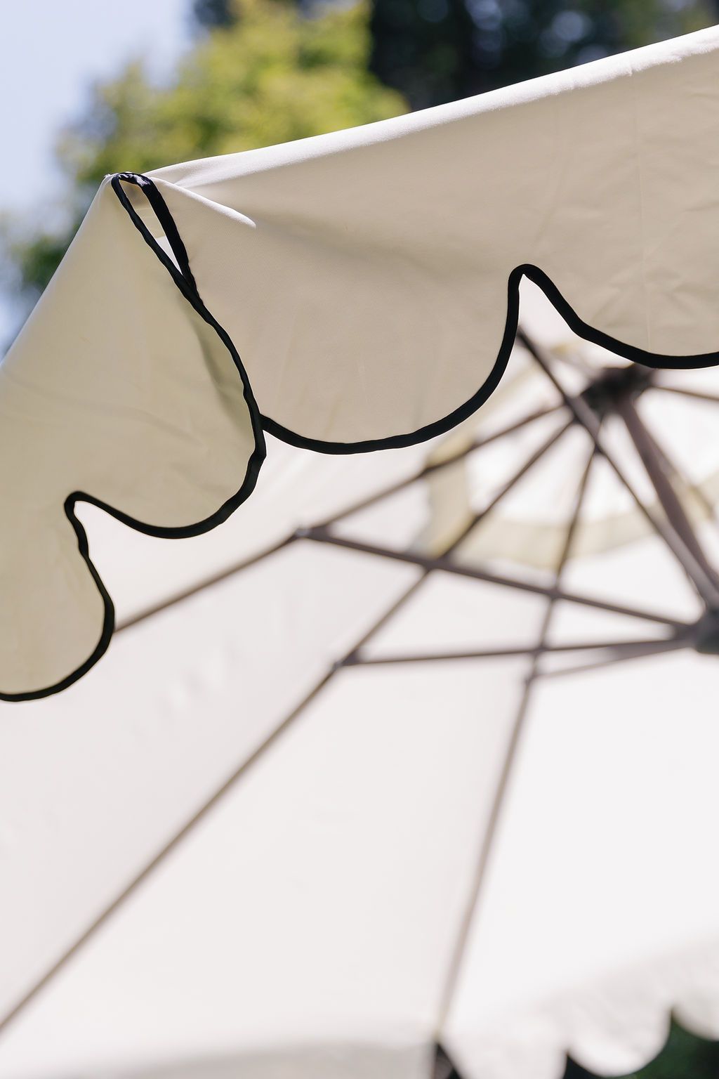Abstract close-up view of a white wedding canopy or umbrella structure showing geometric shadows.