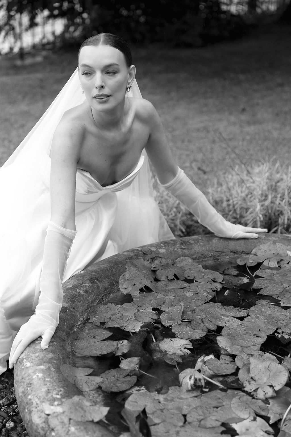 A series of artistic black and white photos showing hands delicately touching leaves in a garden setting in Lake Como.