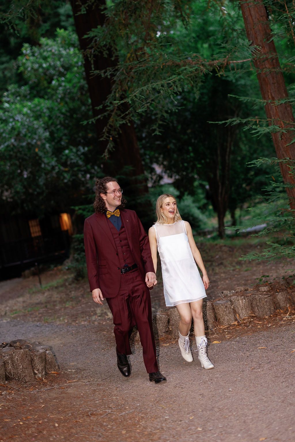 Couple taking a casual stroll along a forest path at dusk.