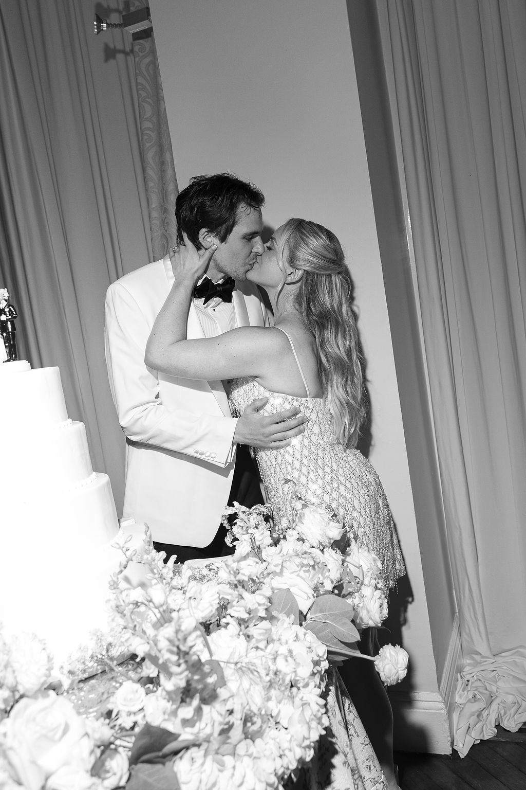 A series of black and white wedding photos showing a romantic first dance with the bride's dress flowing elegantly on Long Island.