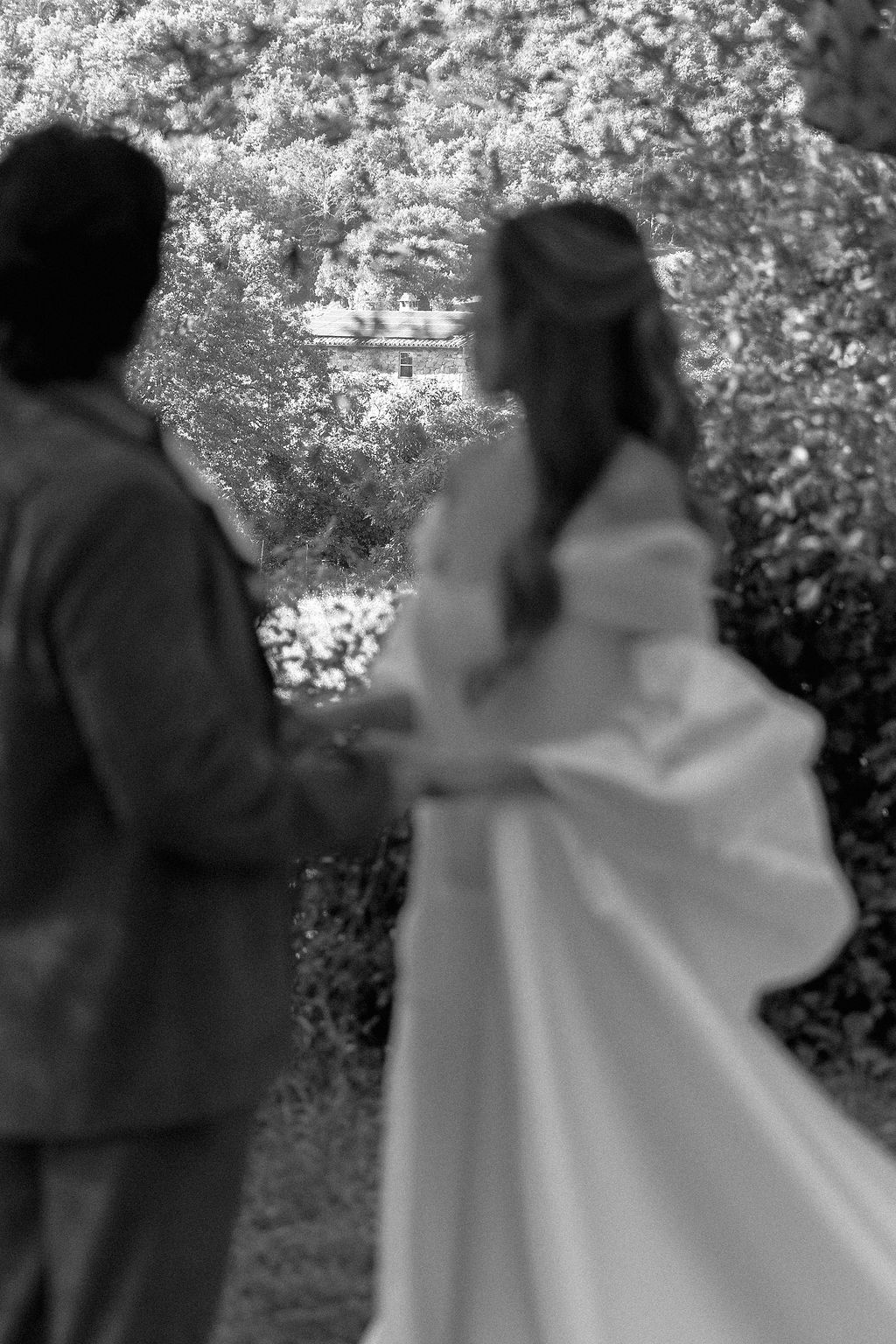 A couple dancing together outdoors with cherry blossoms in the background, creating a romantic silhouette in Tuscany, Italy.