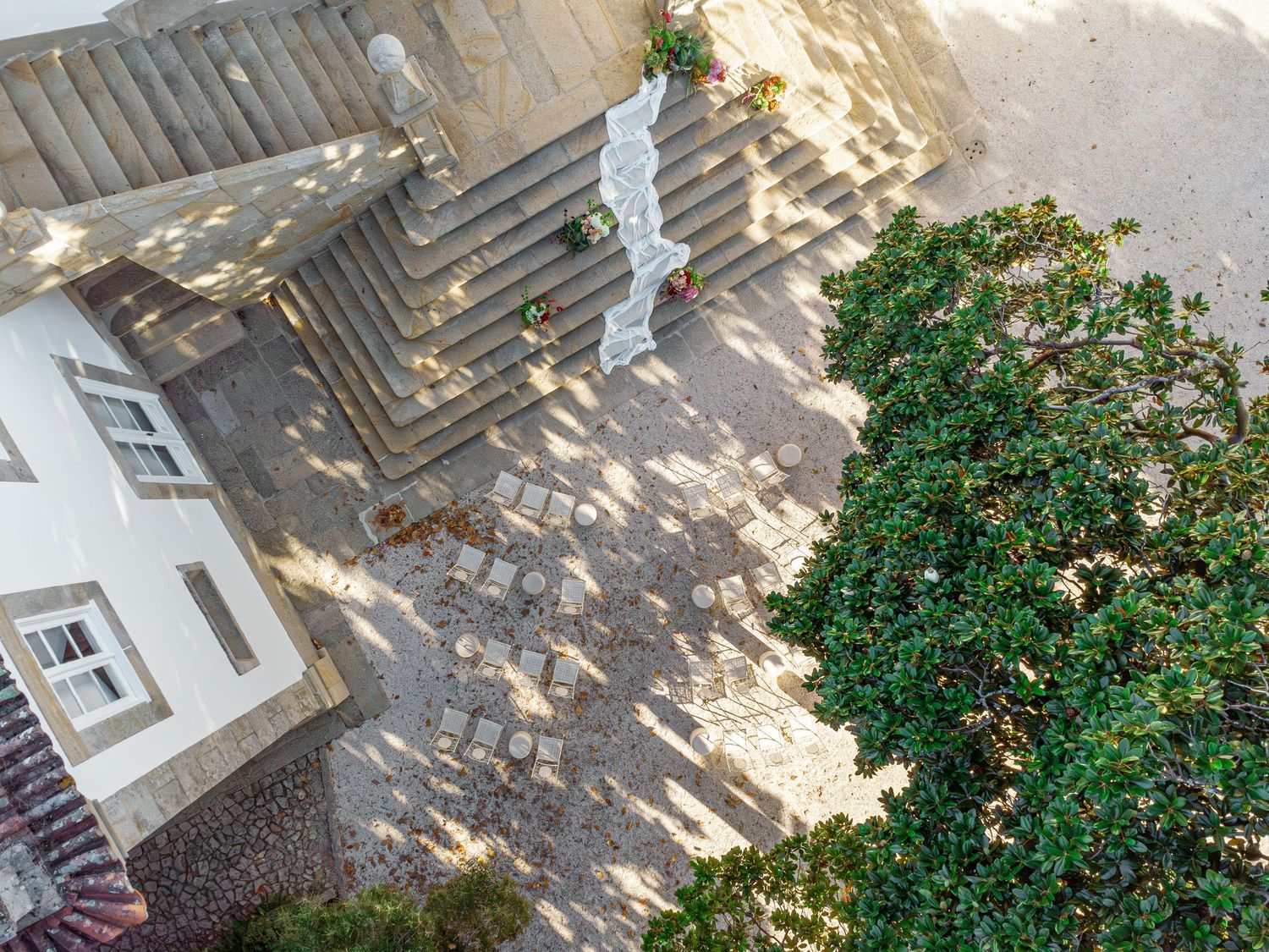 Aerial view of a garden path with stone pavers and lush greenery along the edges in Portugal.