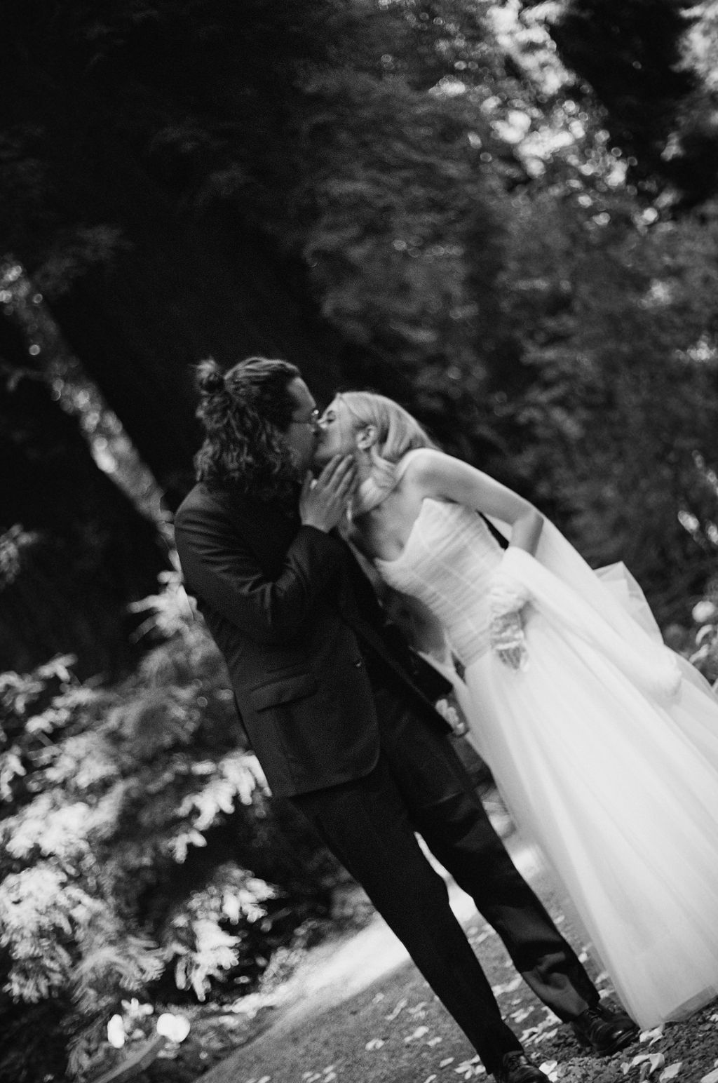 Black and white romantic wedding photo sequence showing a couple dipping in a dance move outdoors.