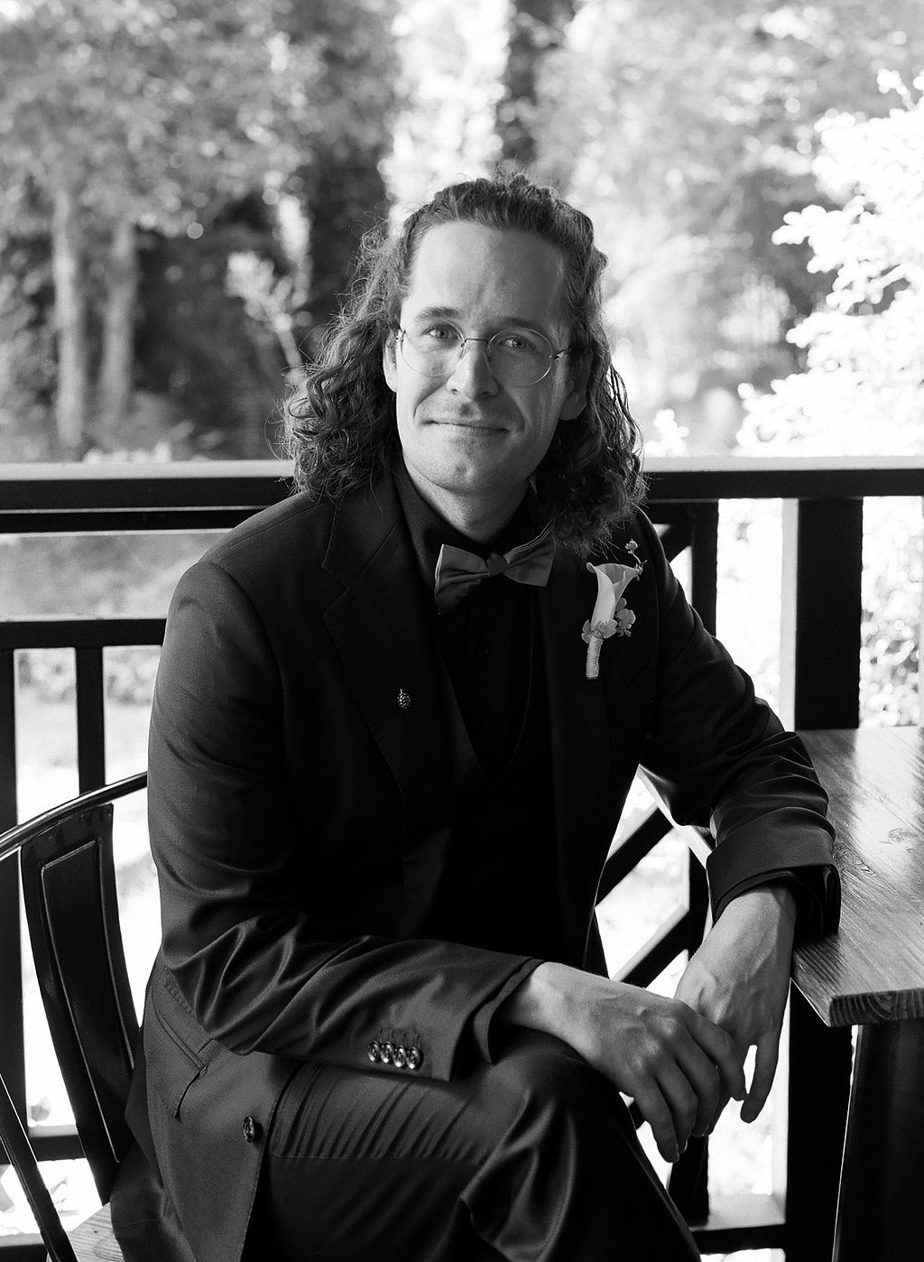 A black and white portrait series shows someone posing on a porch railing in casual attire.