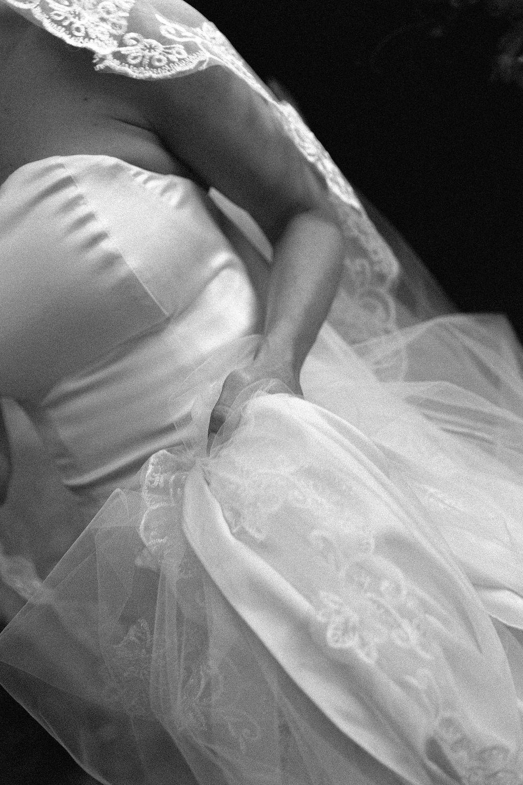 Close-up detail of delicate white lace and tulle fabric from a wedding dress in Portugal.