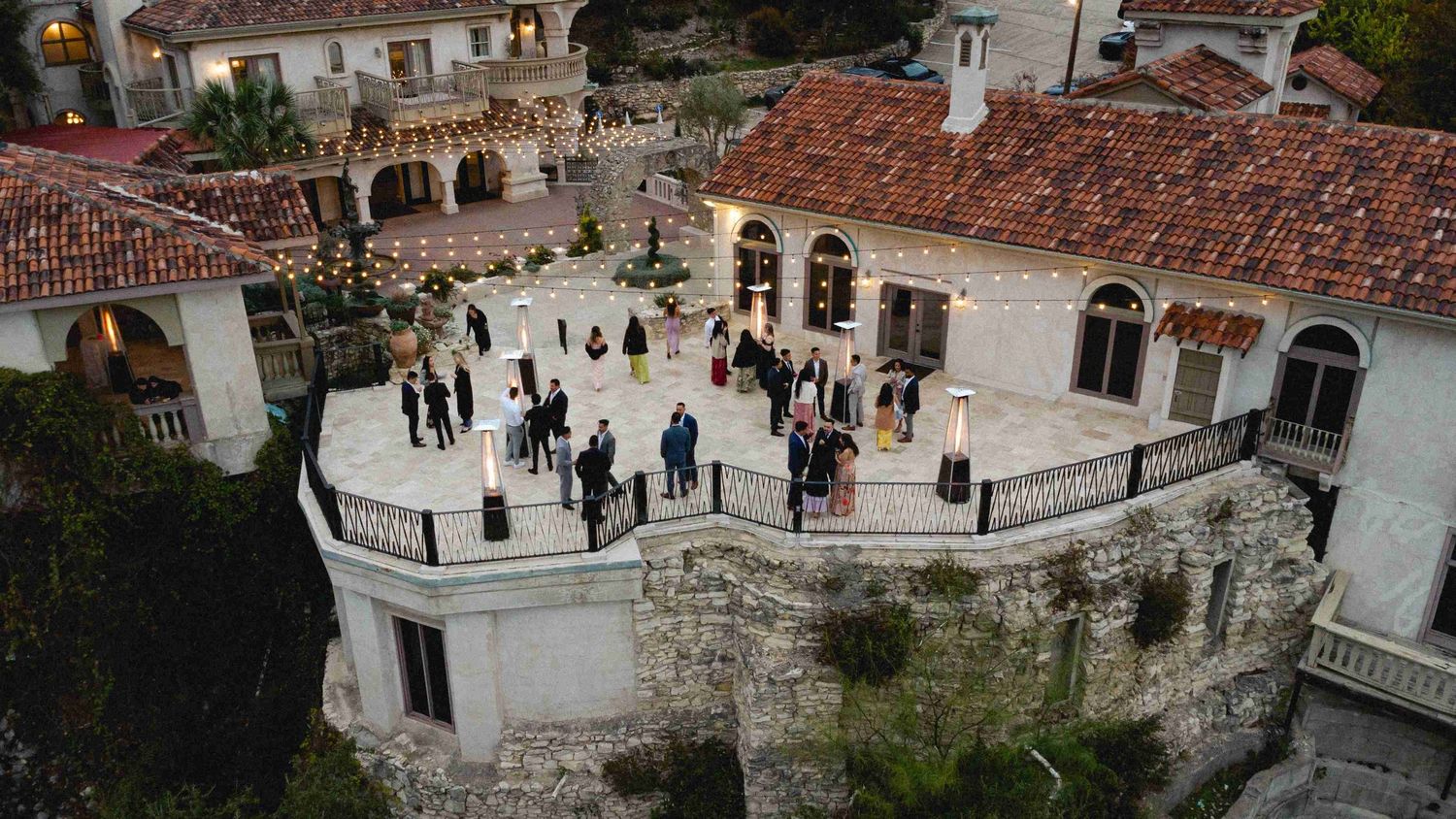 Panoramic view of tourists exploring the walled city of Dubrovnik with its distinctive red rooftops and ancient architecture.