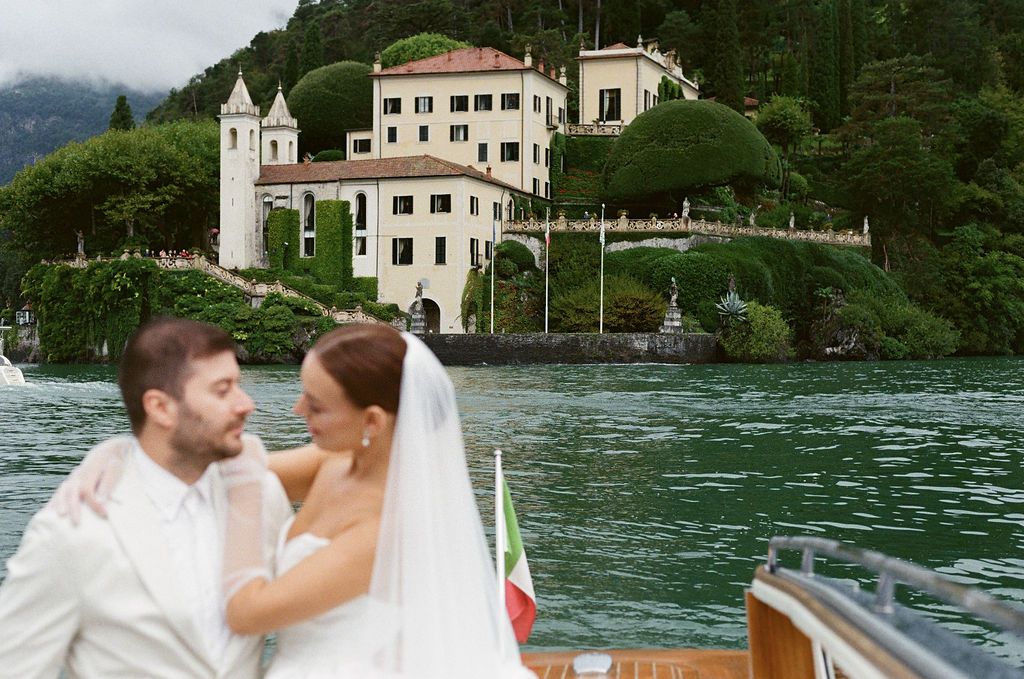 A romantic lakeside scene with a villa and mountains in the background on Lake Como.