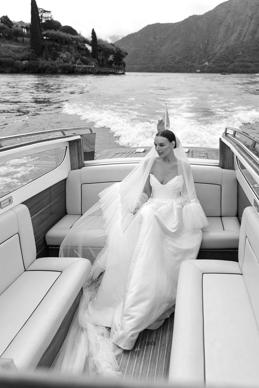 A sequence of black and white photos showing a bride in a speedboat on a scenic lake with mountains in Lake Como.