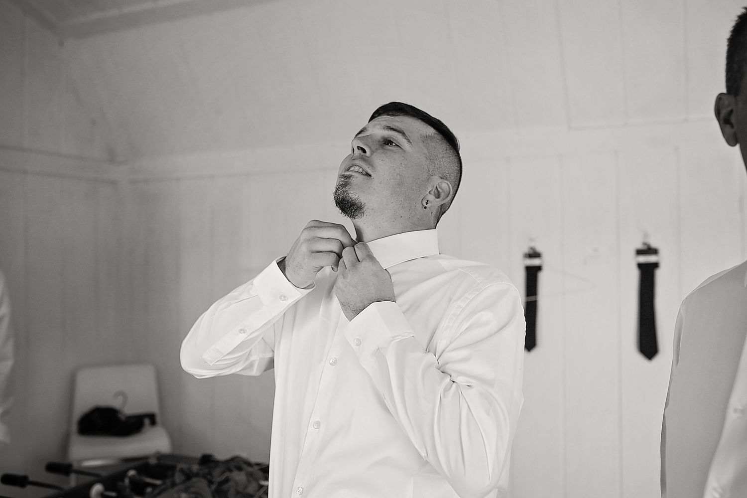 A black and white collage shows a person getting ready in formal attire with various close-up shots of adjusting details.