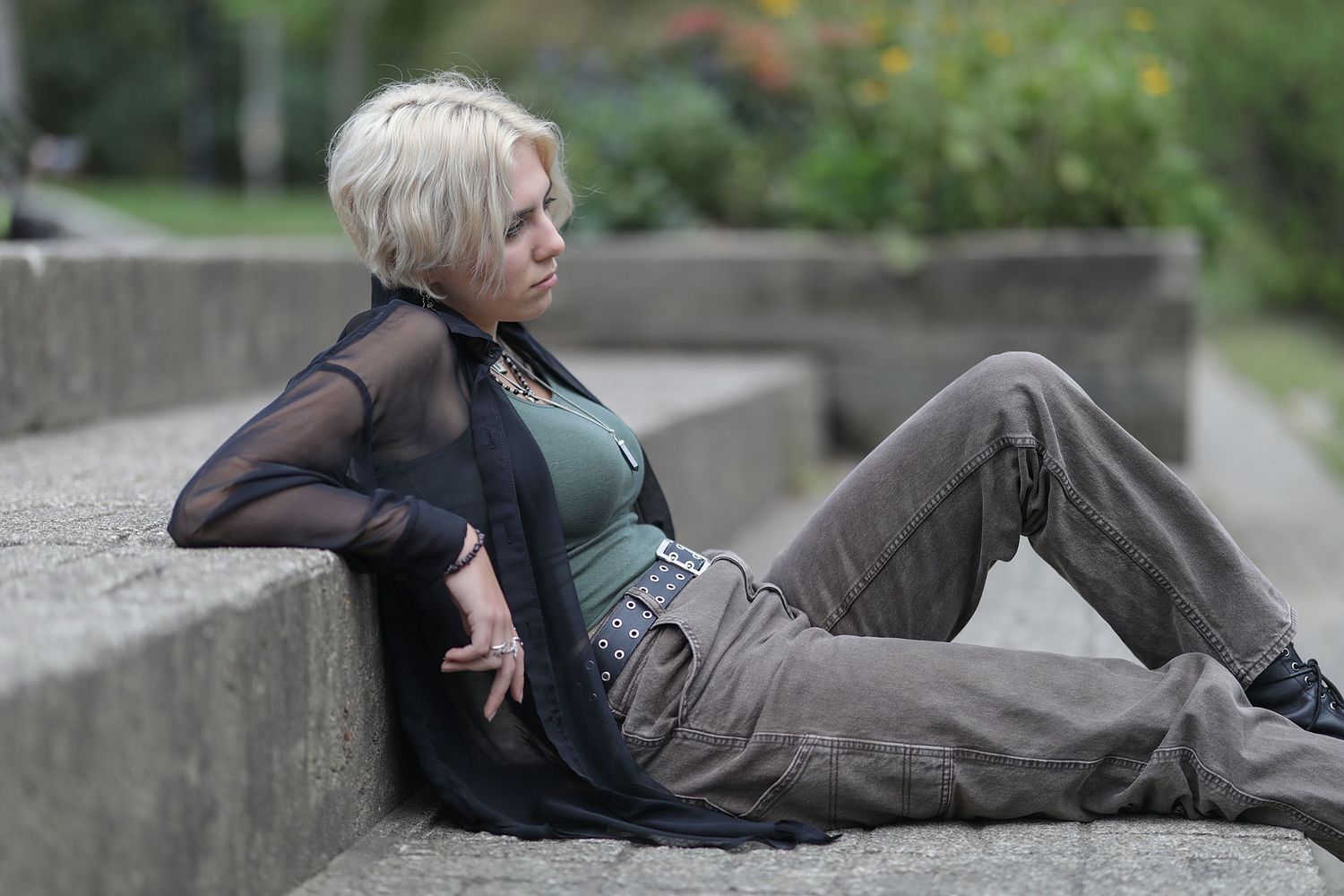 A sequence of dynamic dance moves performed on concrete steps in an outdoor setting.