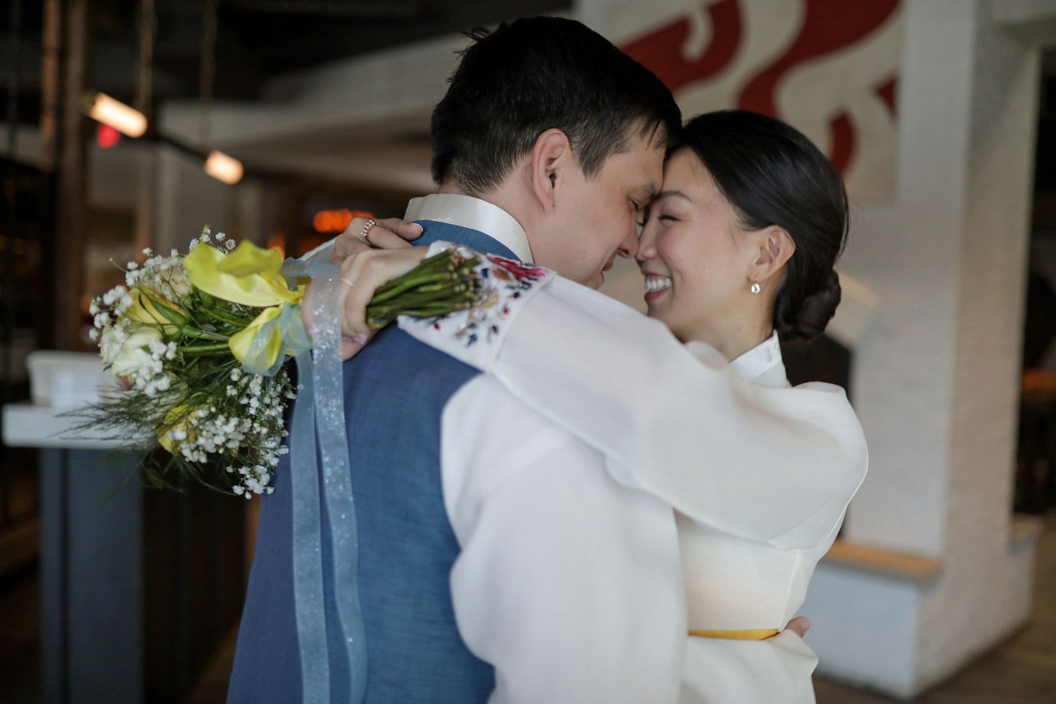A joyful wedding couple shares tender kisses and intimate moments during their celebration.