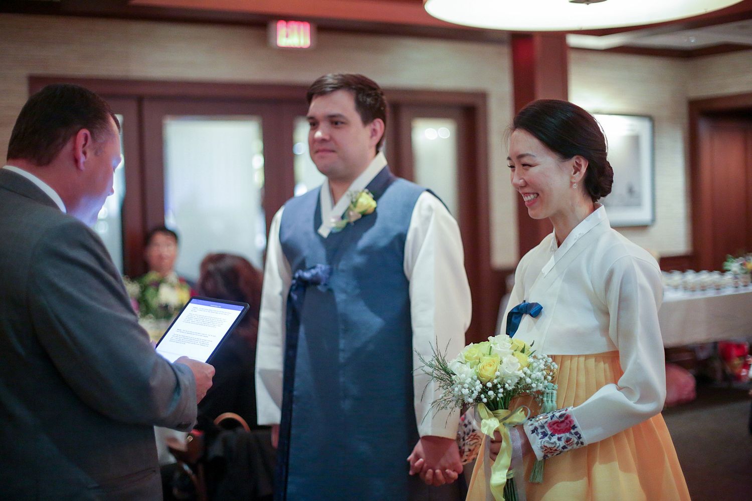A series of photos showing wedding ceremony moments with the couple exchanging vows and rings in an indoor venue.