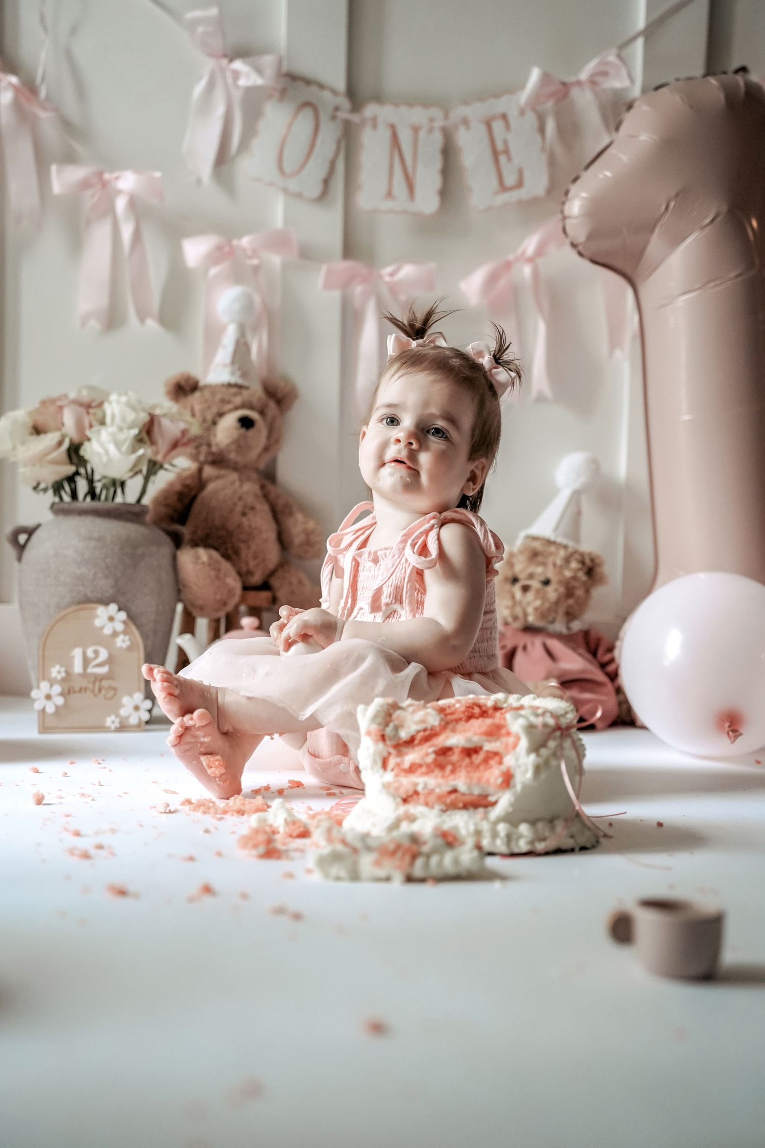 Cake smash photo collage showing a messy pink dessert celebration with stuffed animals and party decorations.