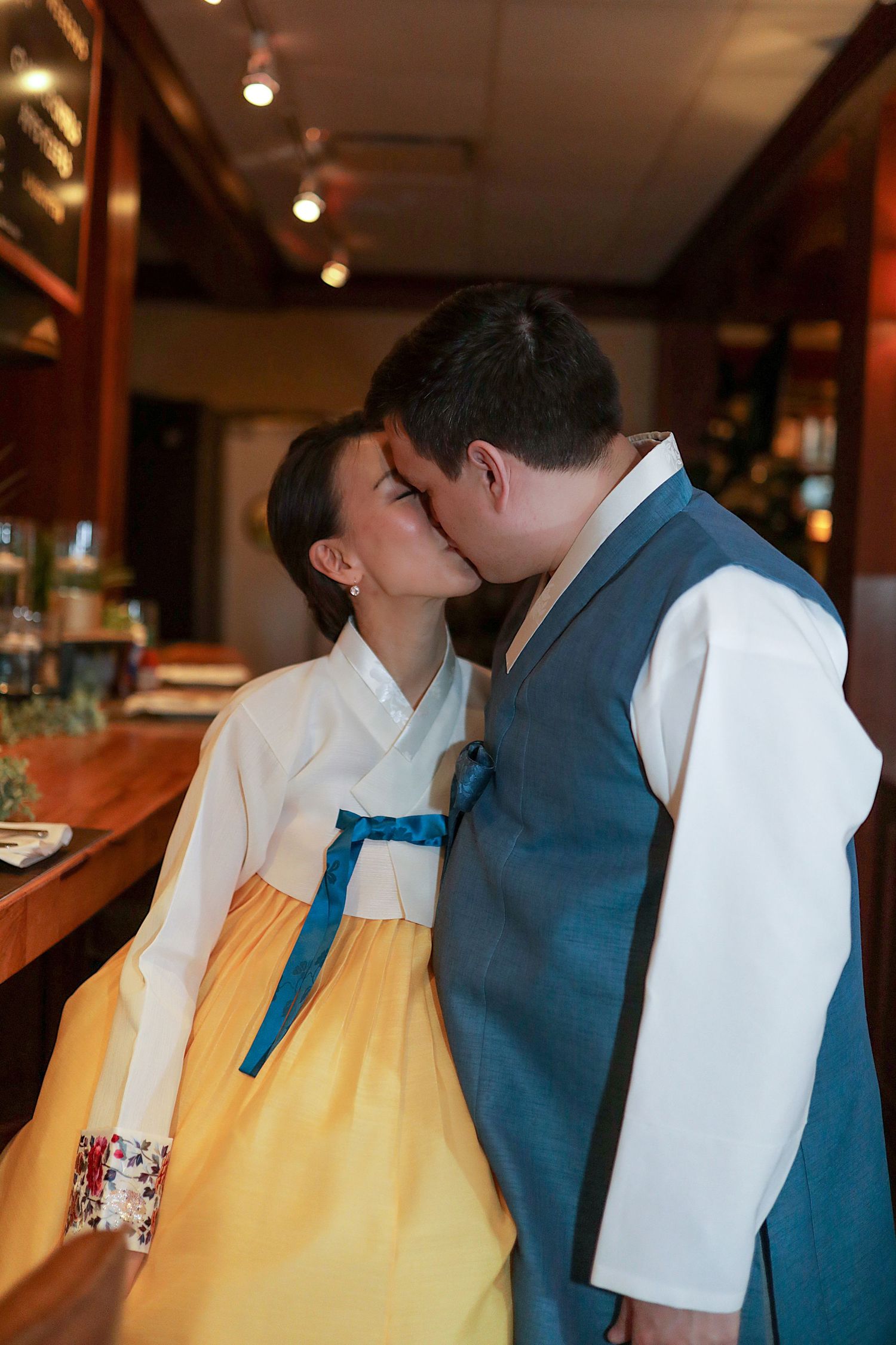 A series of candid romantic moments showing a couple in a yellow dress and blue suit sharing tender kisses.