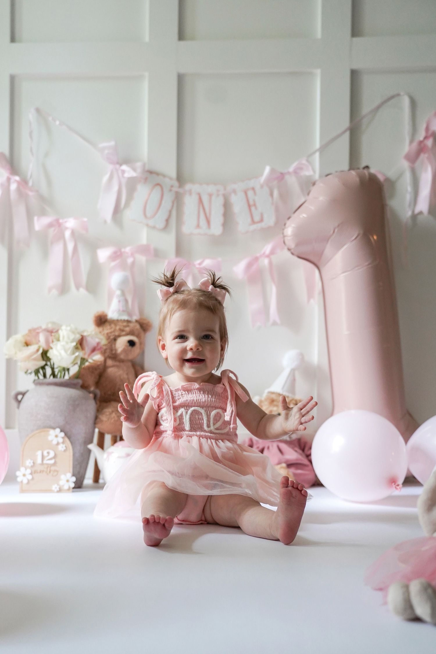 Collage of pink nursery decor featuring stuffed animals, balloons, and party decorations in a soft pastel color scheme.