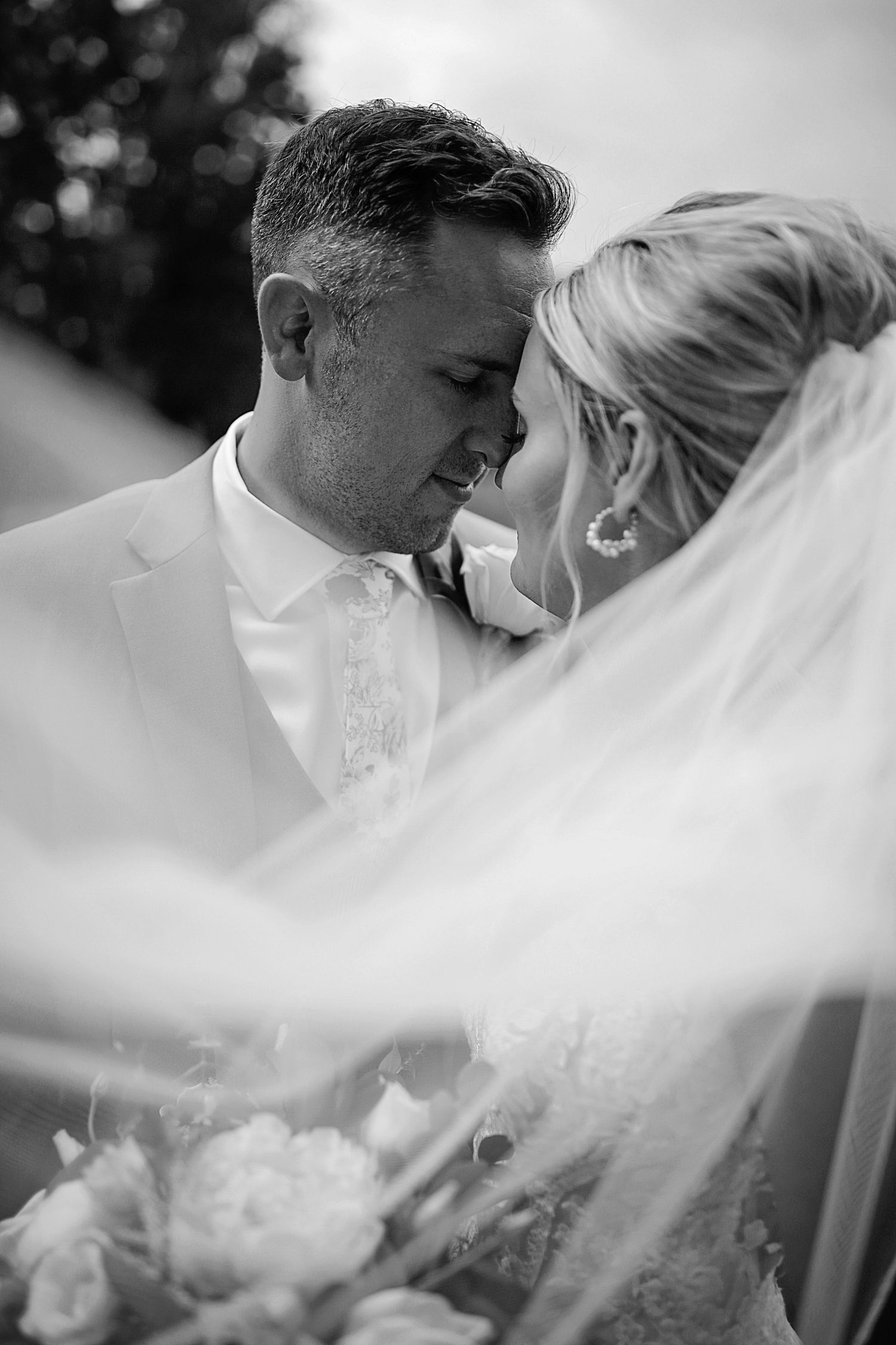 Romantic black and white wedding portraits captured through flowing bridal veil. Cleveland wedding photographer.