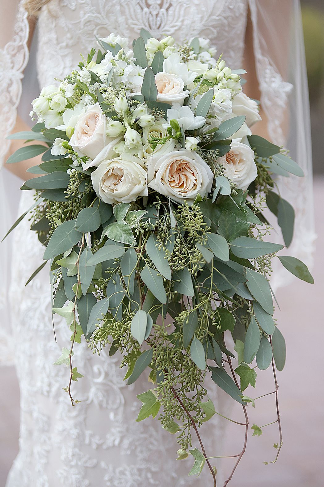Cascading bridal bouquet with white roses, eucalyptus leaves and greenery. Wedding Photographer in Cleveland Ohio
