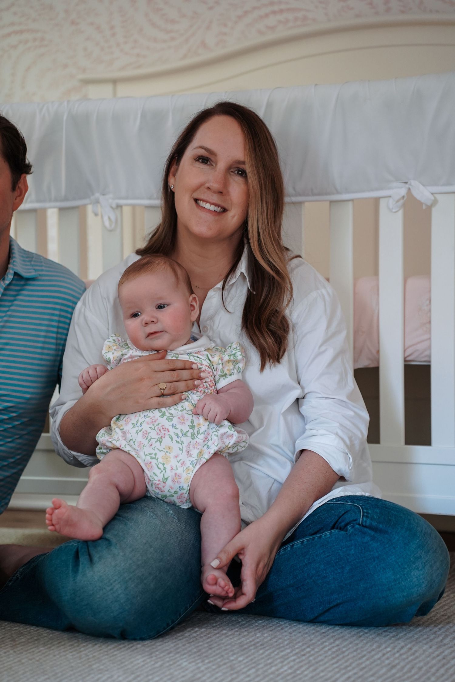 A series of tender moments showing an adult and baby relaxing together on a white crib mattress.