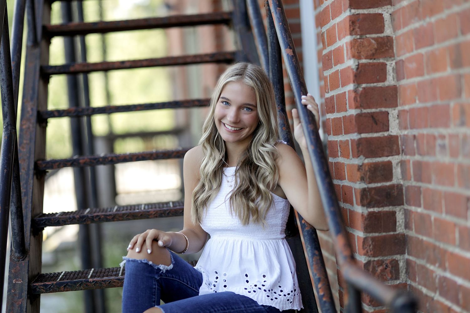 A sequence of photos shows someone posing and interacting near a brick wall in natural light.