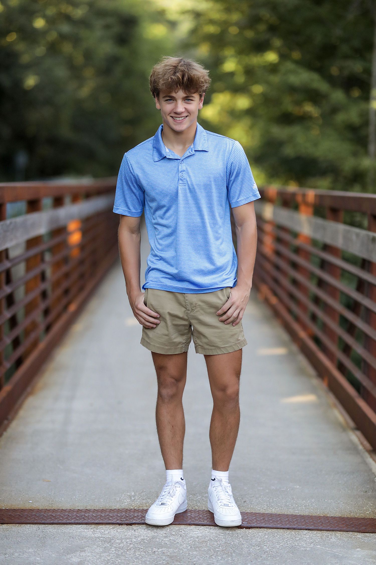 Four linked images show a person in a light blue polo and khaki shorts standing on a wooden bridge in a park setting.