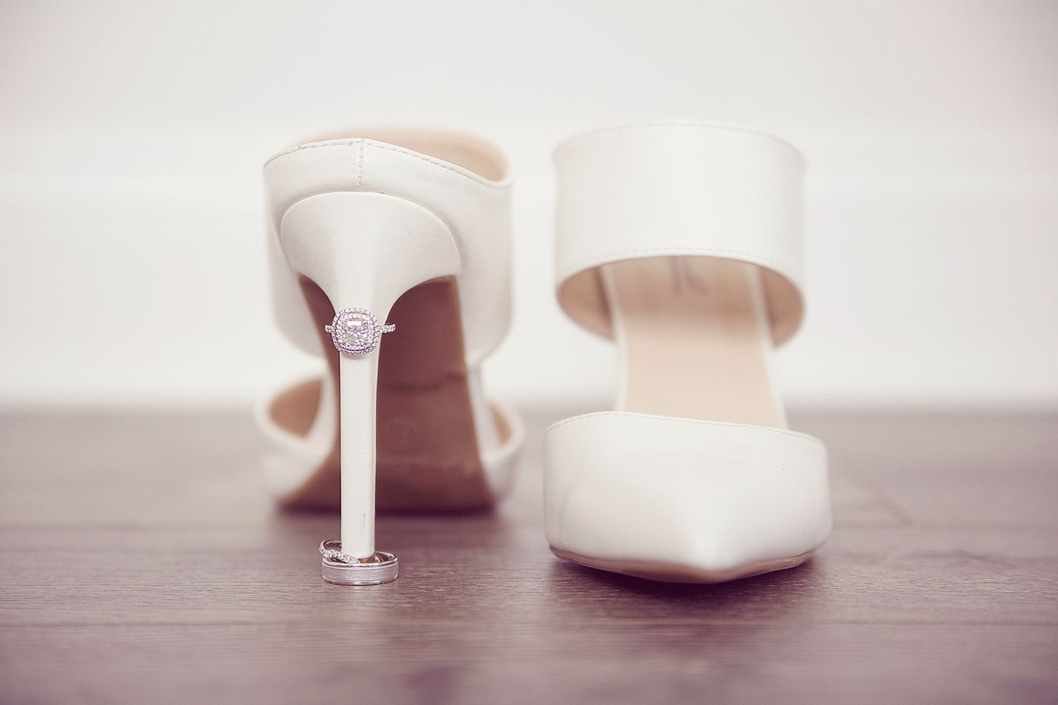 Classic white bridal heels on wooden surface with soft focus. Wedding Photographer in Cleveland Ohio