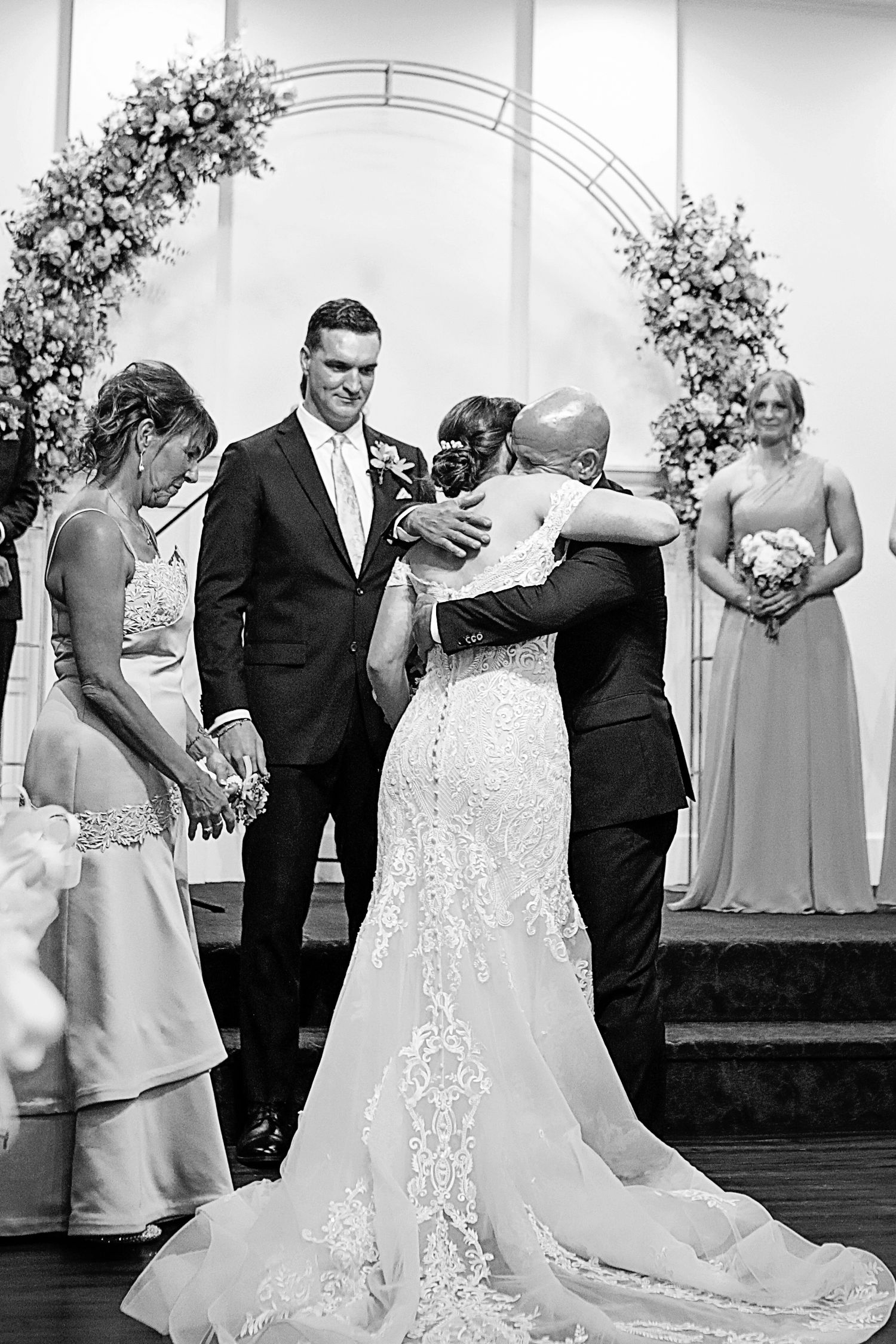 Black and white wedding photo series showing intimate dance moments between couples during a reception celebration.