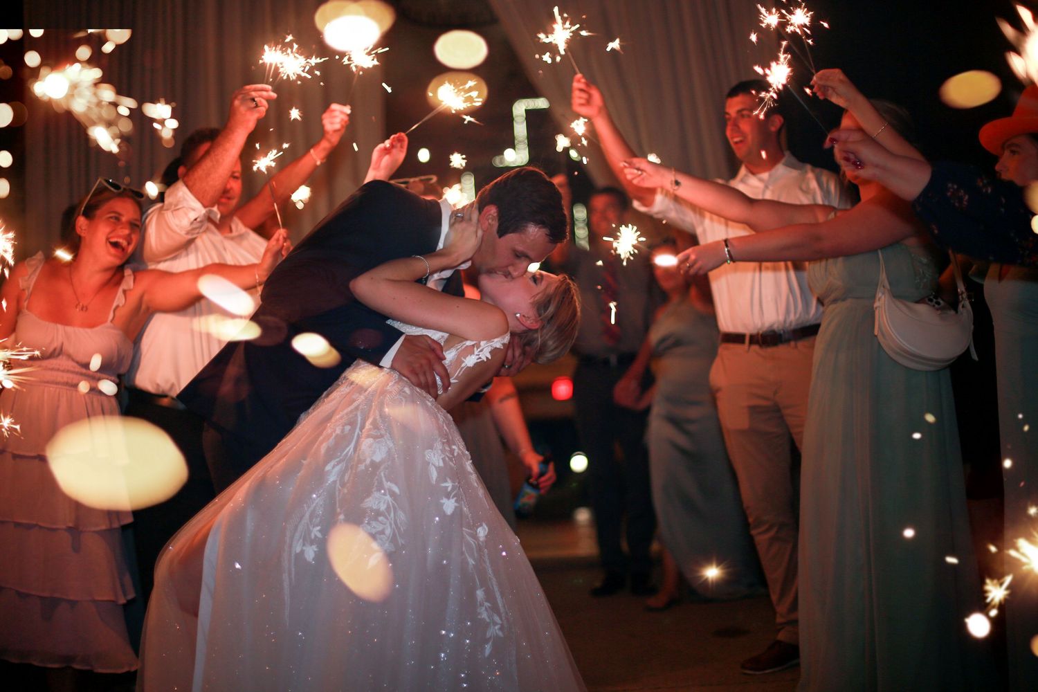 Wedding guests hold sparklers creating a magical exit tunnel for the newlyweds on the dance floor. Cleveland wedding photographer.