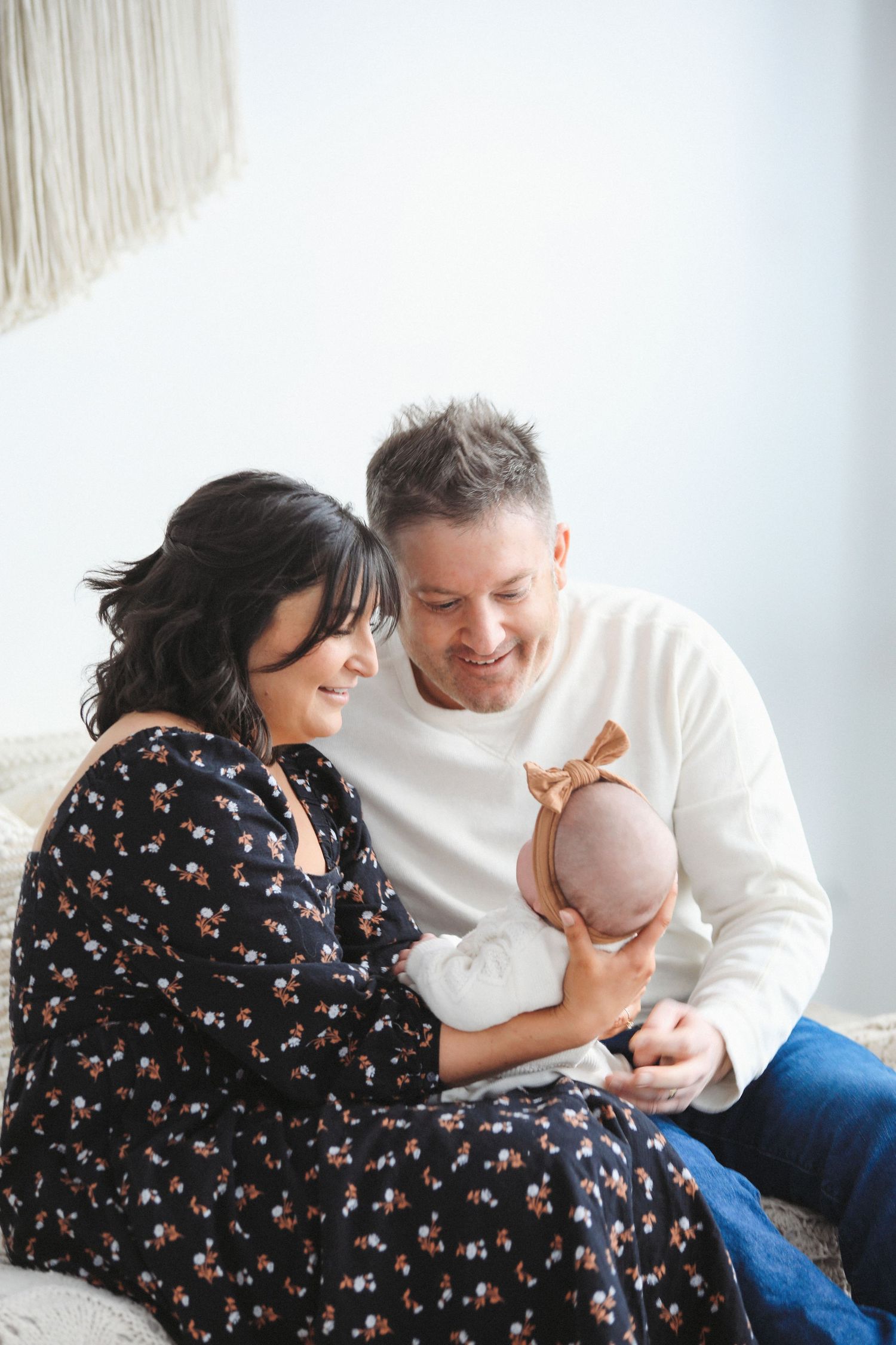 A family shares tender moments together in a series of four connected photos showing affection and bonding.