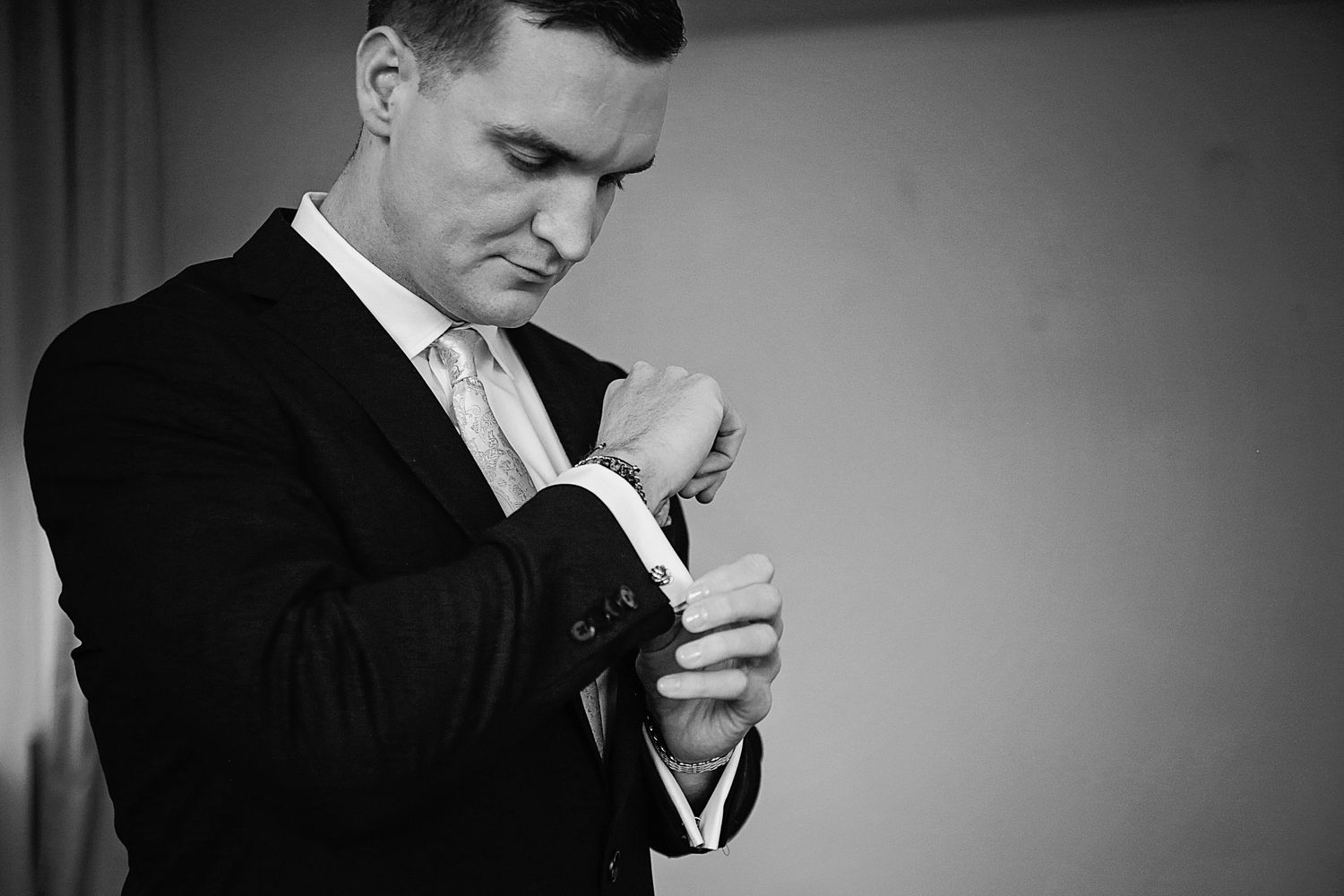 Black and white photo series showing a person in formal attire drinking from a glass in three sequential shots.