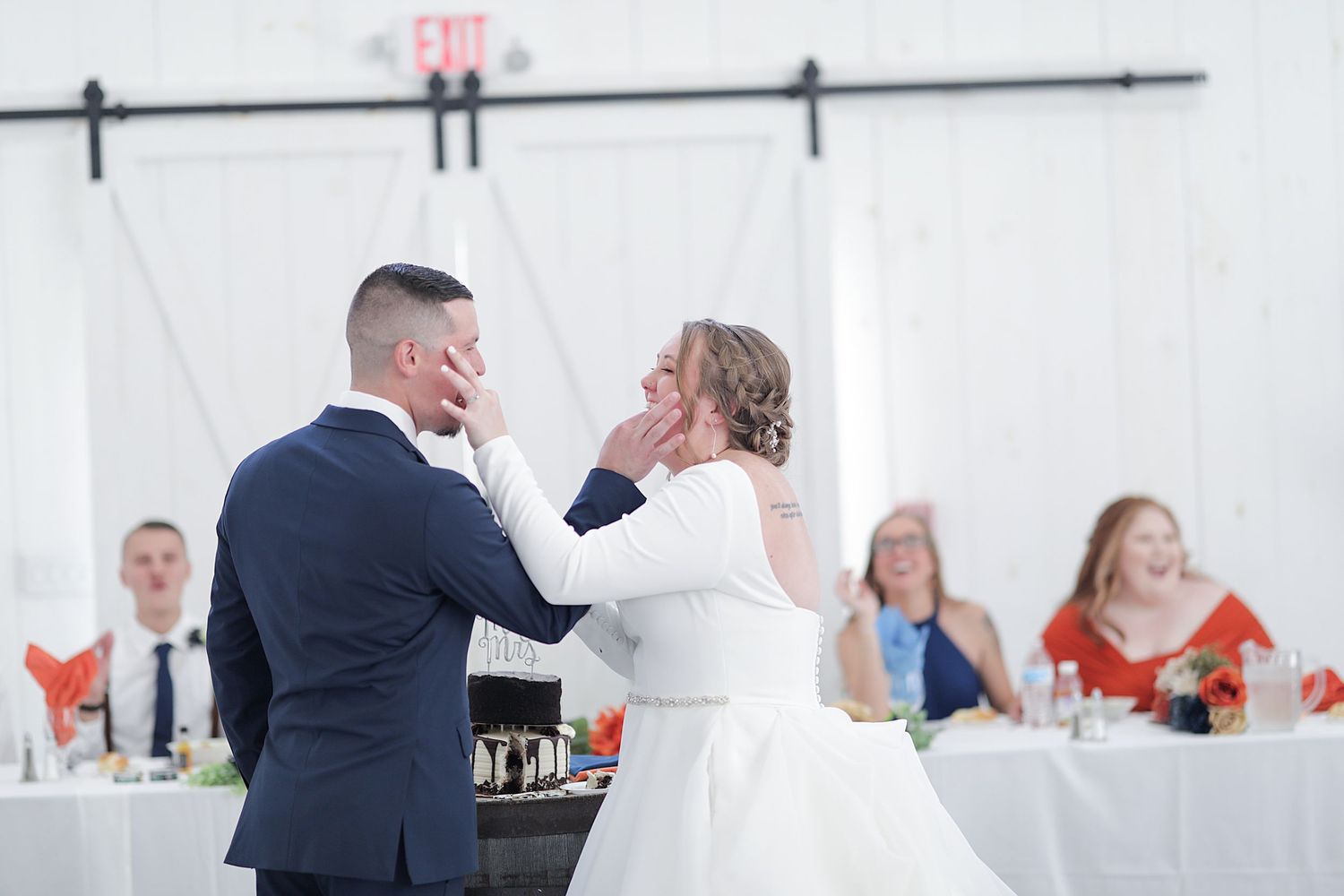 Wedding reception dance captured inside a modern white venue space.