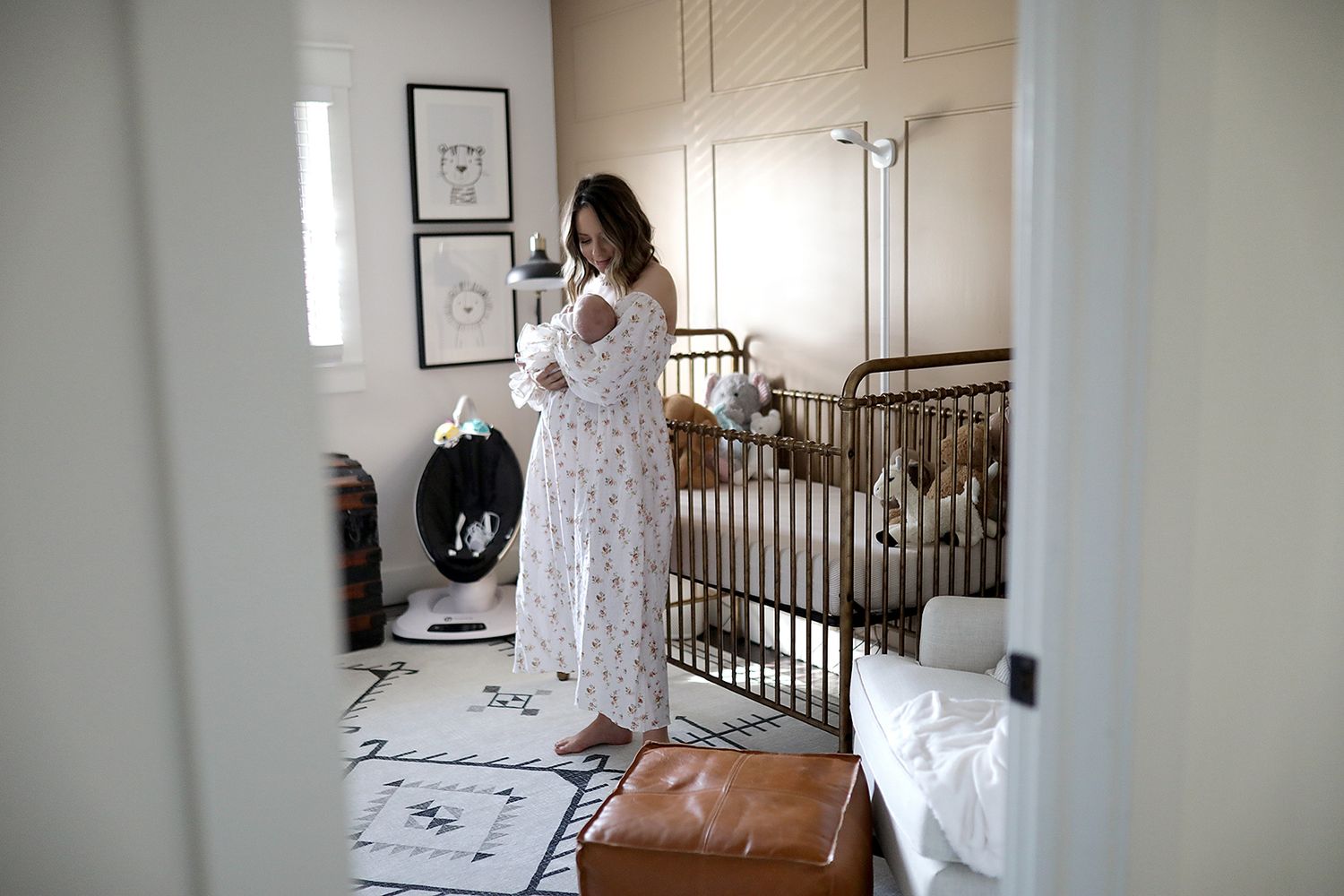 Nursery interior with white crib and geometric pattern rug. Newborn photographer Strongsville, Ohio.