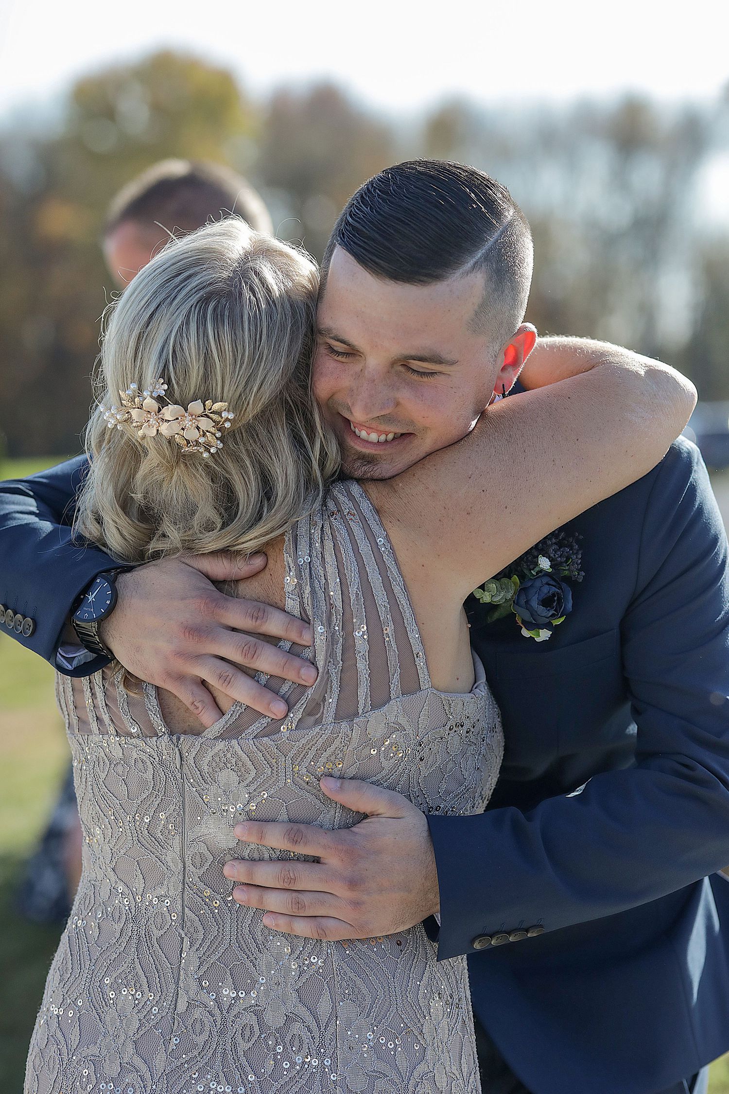Wedding couple sharing emotional embrace outdoors during autumn photo session.
