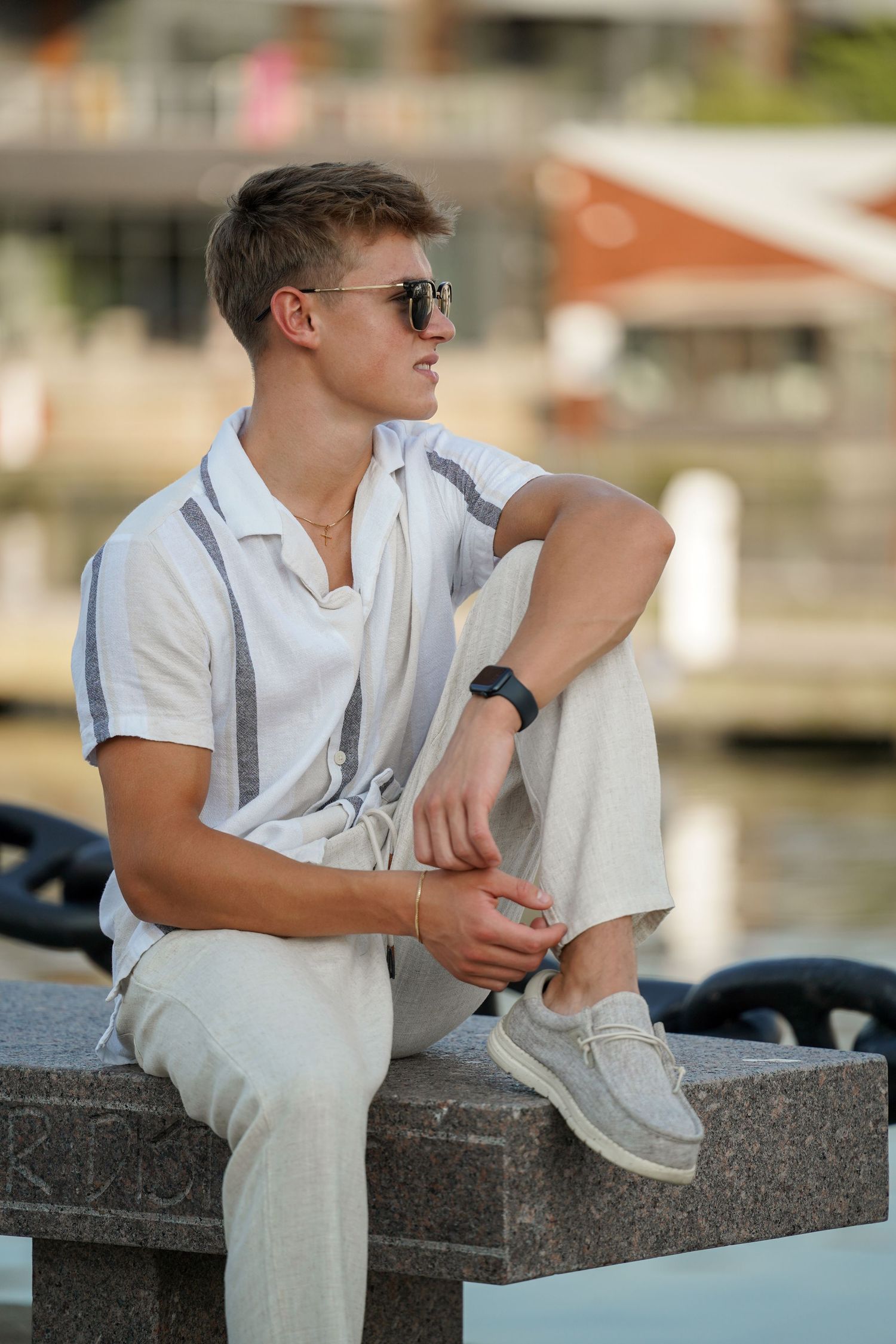 Sequence of images showing someone in a white shirt sitting on a concrete ledge near water.