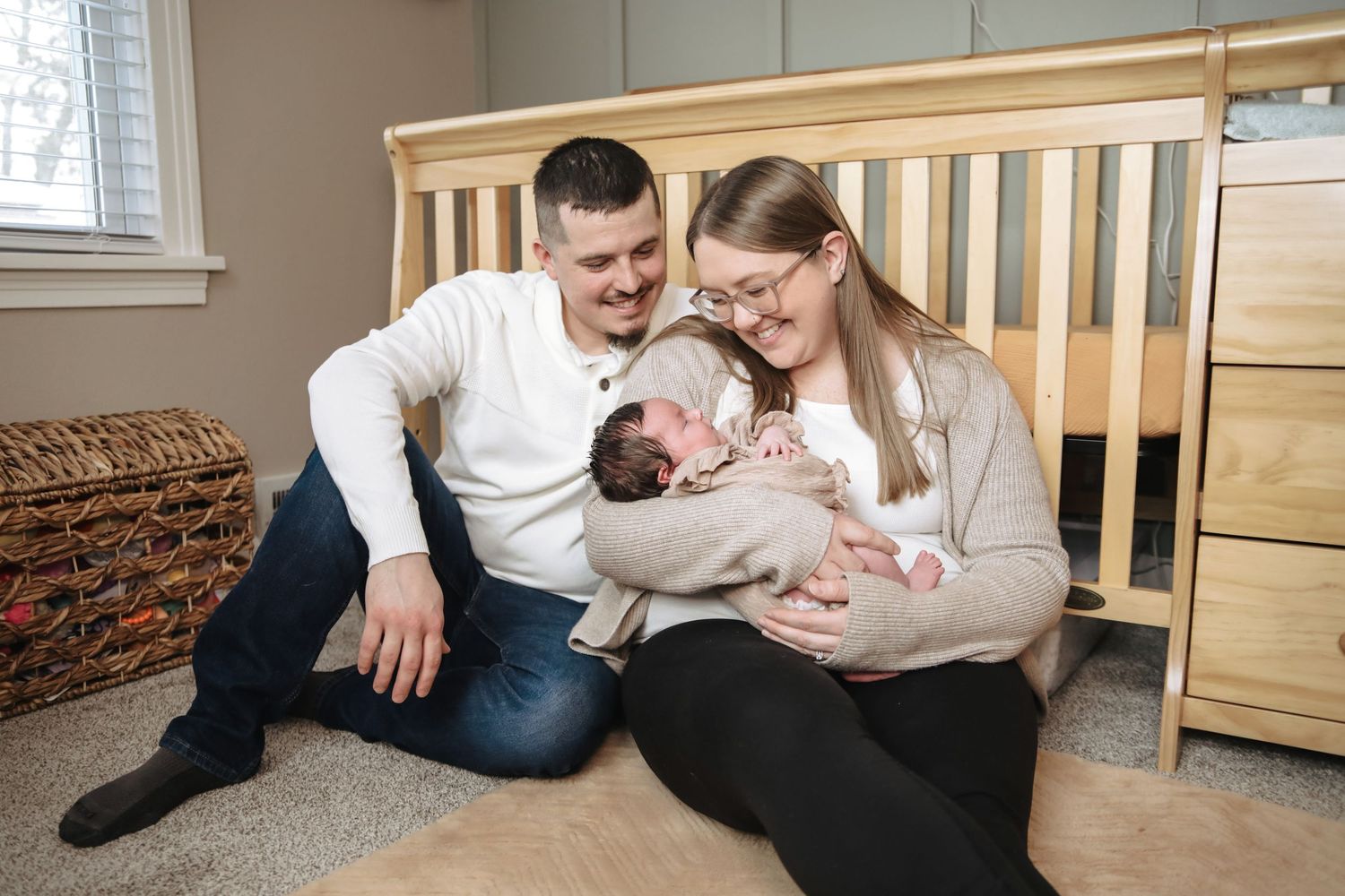 A series of candid family photos showing tender moments with a baby in a cozy home setting.