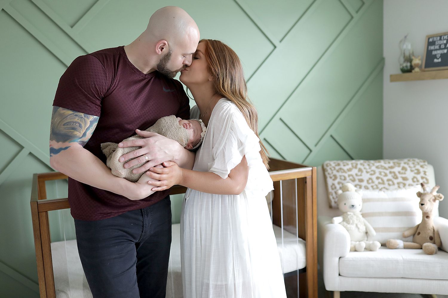 Intimate family portrait session against sage green accent wall. Newborn photographer Medina, Ohio.