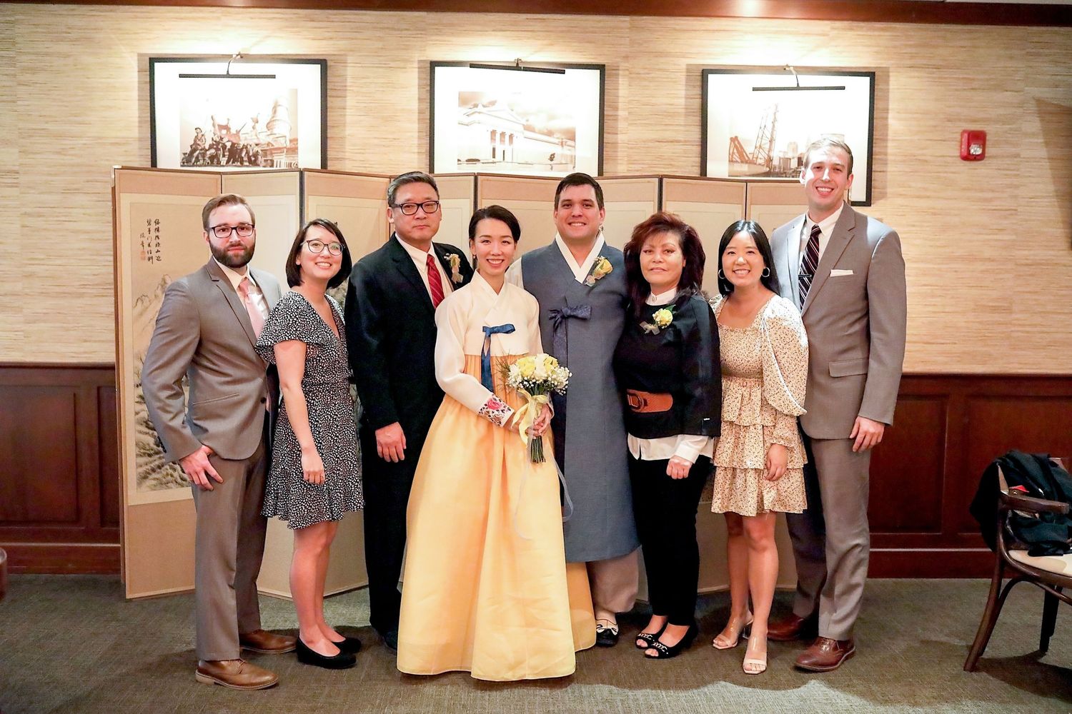 A composite of four images showing formal event attendees posing together against a beige wall.