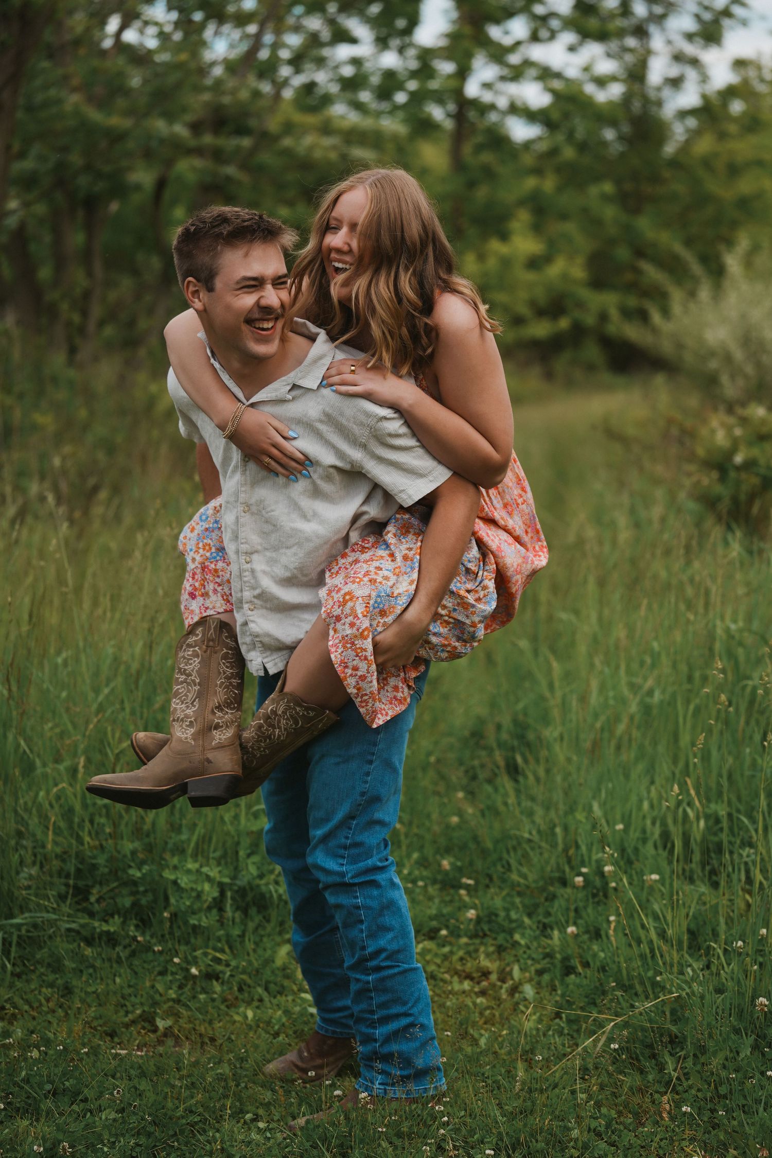 Two people share a joyful moment together outdoors, with one giving a piggyback ride in a grassy field.