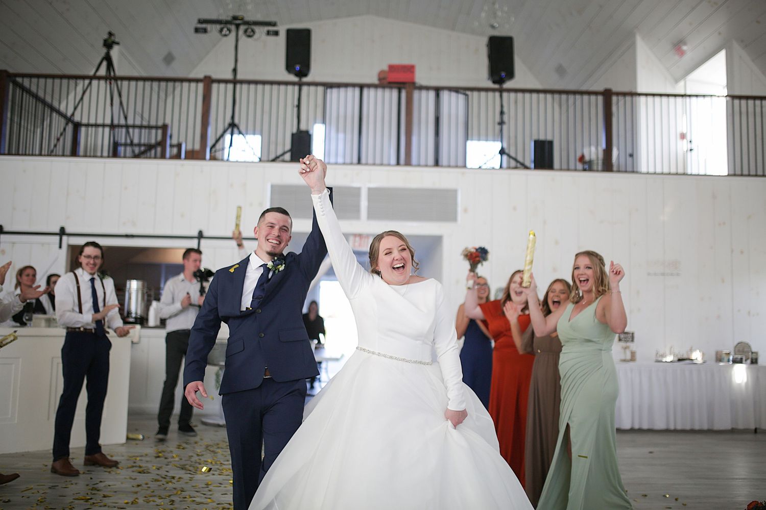 Wedding reception taking place in a modern white industrial venue space.