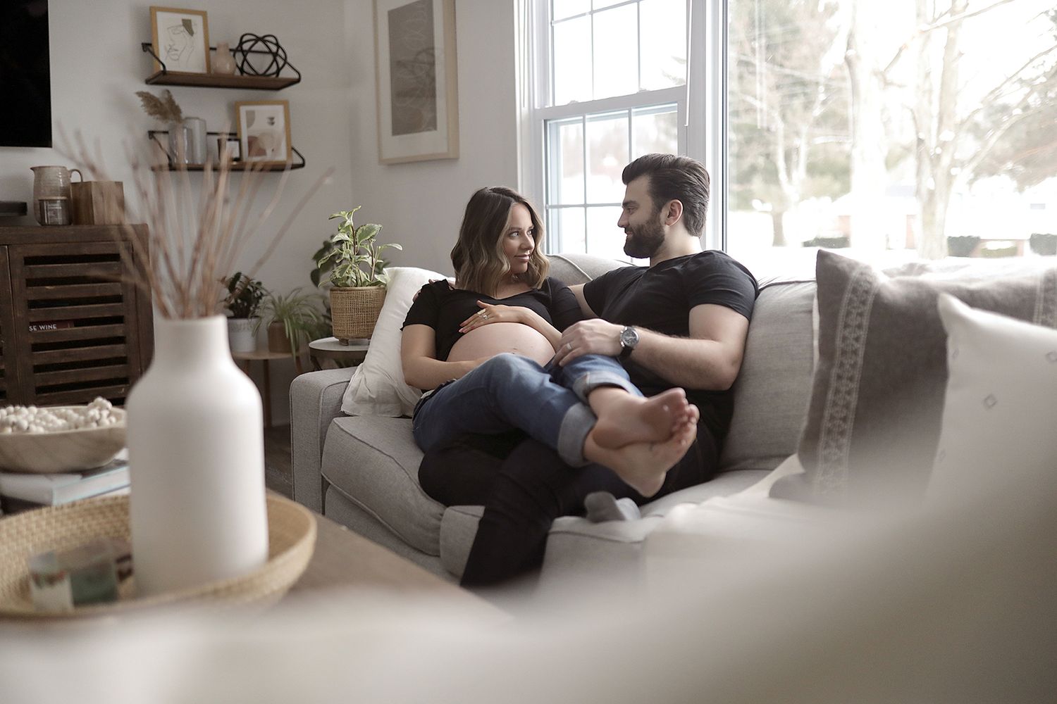 Modern living room with natural lighting and cozy seating area. Maternity photographer Aurora Ohio.