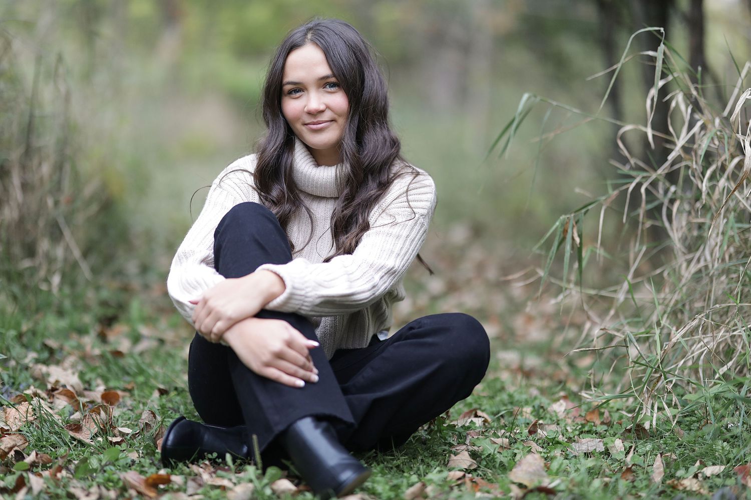 Seven outdoor portraits show a person sitting on grass in casual attire during a nature photo session.